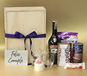 Caja grande con Baileys, barquillos, maní, chocolates, vela aromatizada y sobre